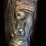 Blindfolded girl and antique timepiece tattoo